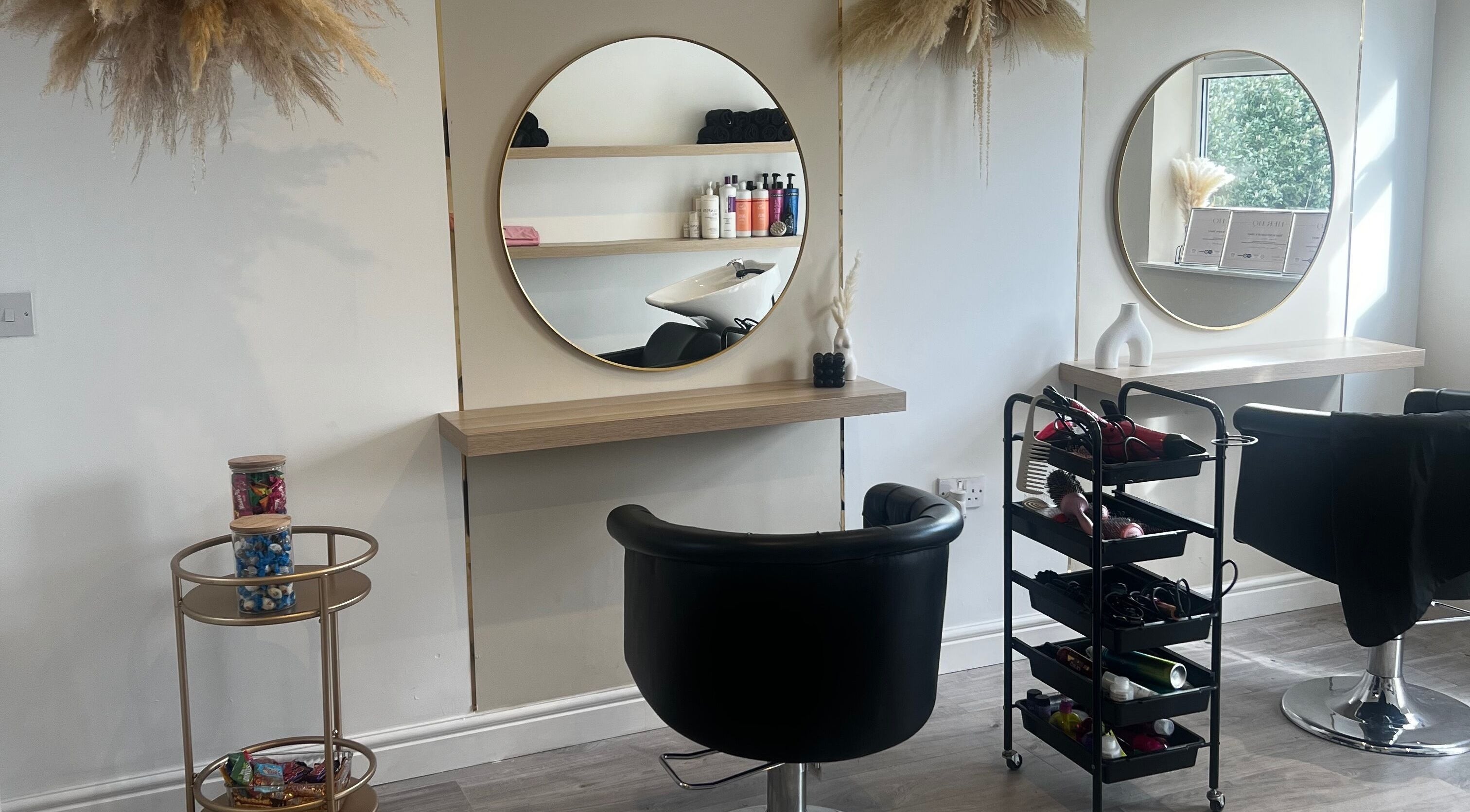 Stylish salon setup at Studio Glow, Huddersfield, England, GB with mirrors and beauty products on display.
