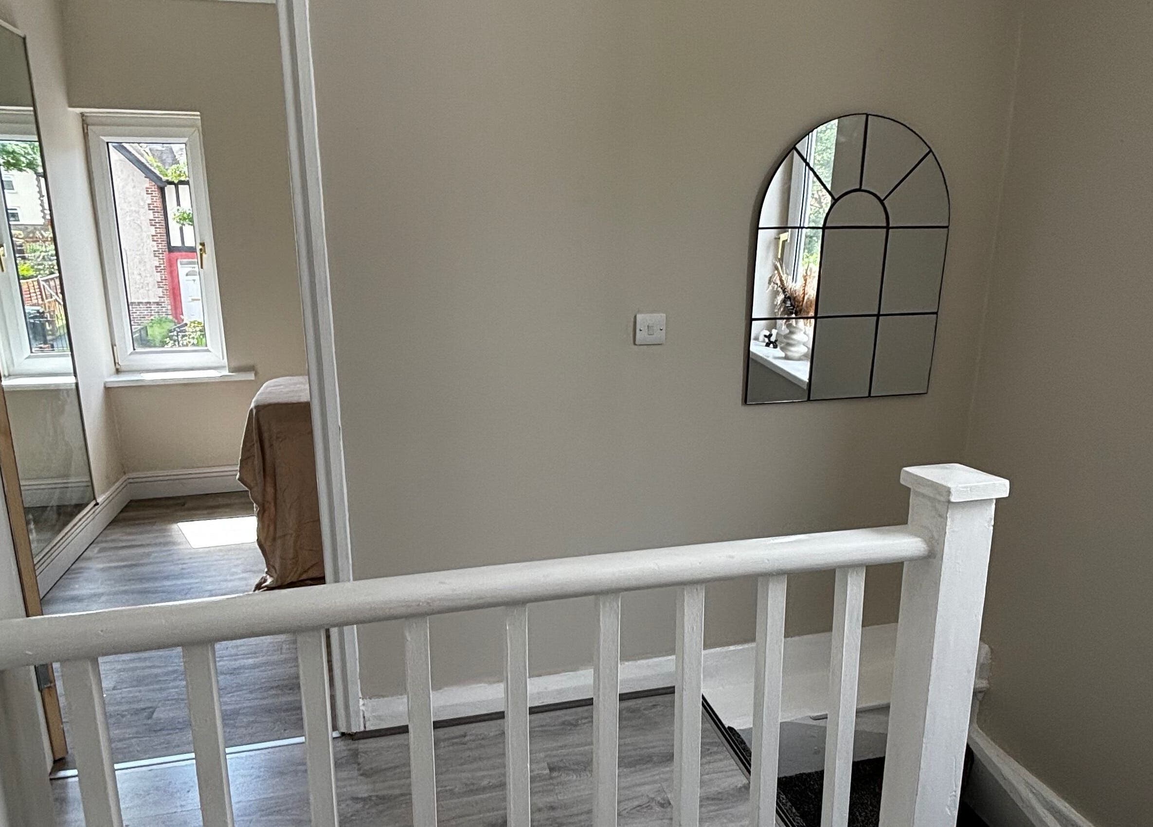 Bright interior hallway with mirror at Studio Glow, Huddersfield, England, GB.