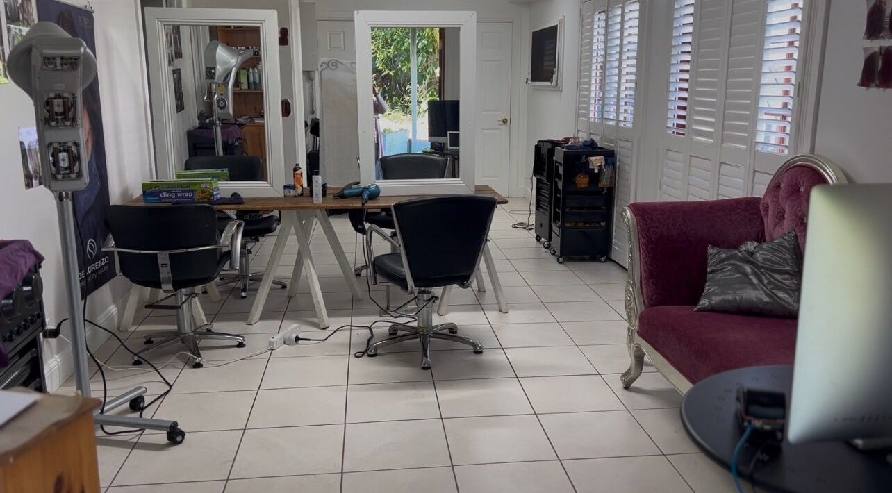Modern salon interior at GangNam Style Hair Indooroopilly, Queensland, AU, with stylish seating and large mirrors.
