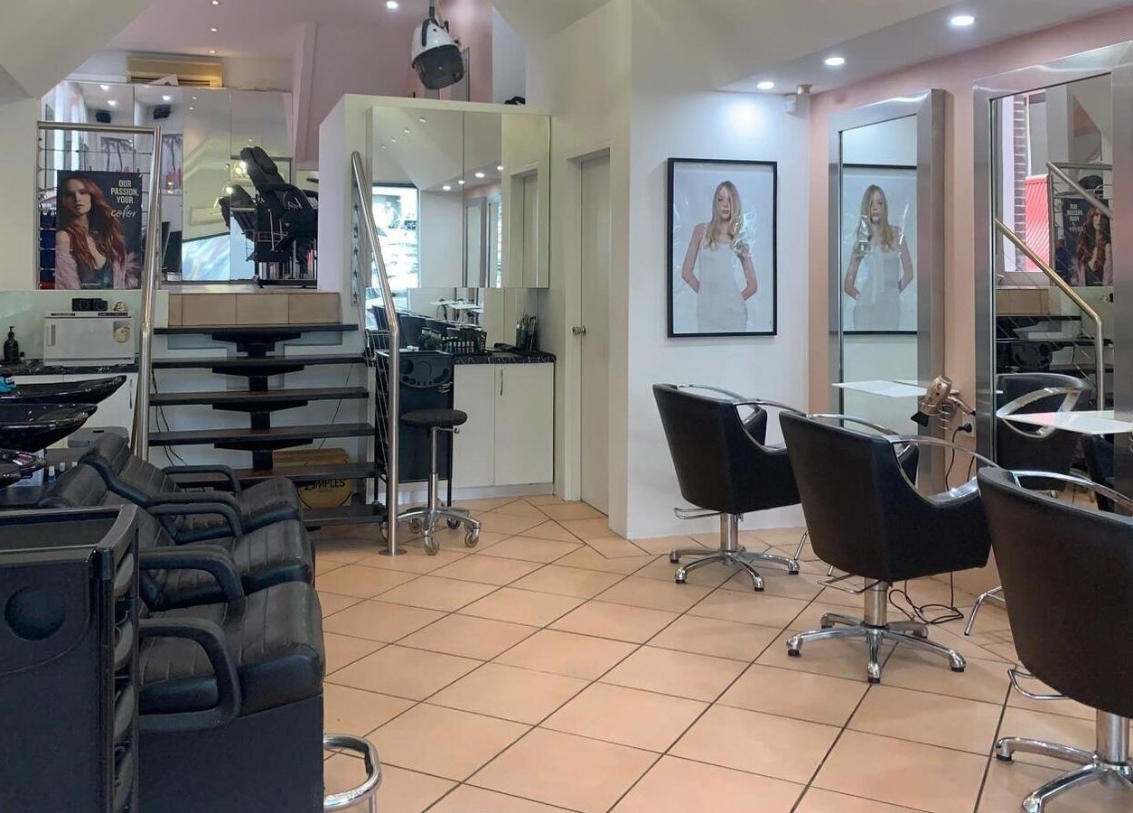 Modern interior of The Edge Hair Salon in Wahroonga, New South Wales, AU with stylish chairs and mirrors.