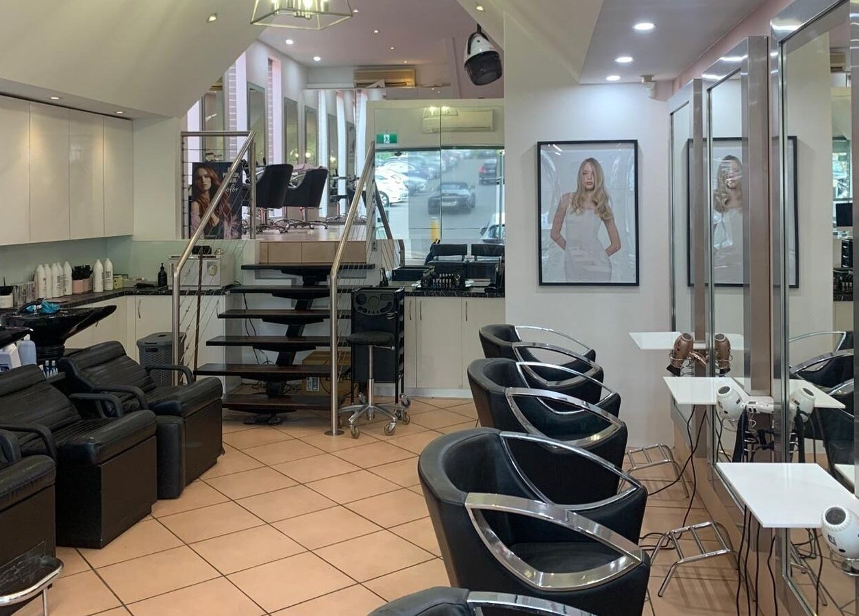 Modern interior of The Edge Hair Salon in Wahroonga, New South Wales, AU with sleek chairs and mirrors.