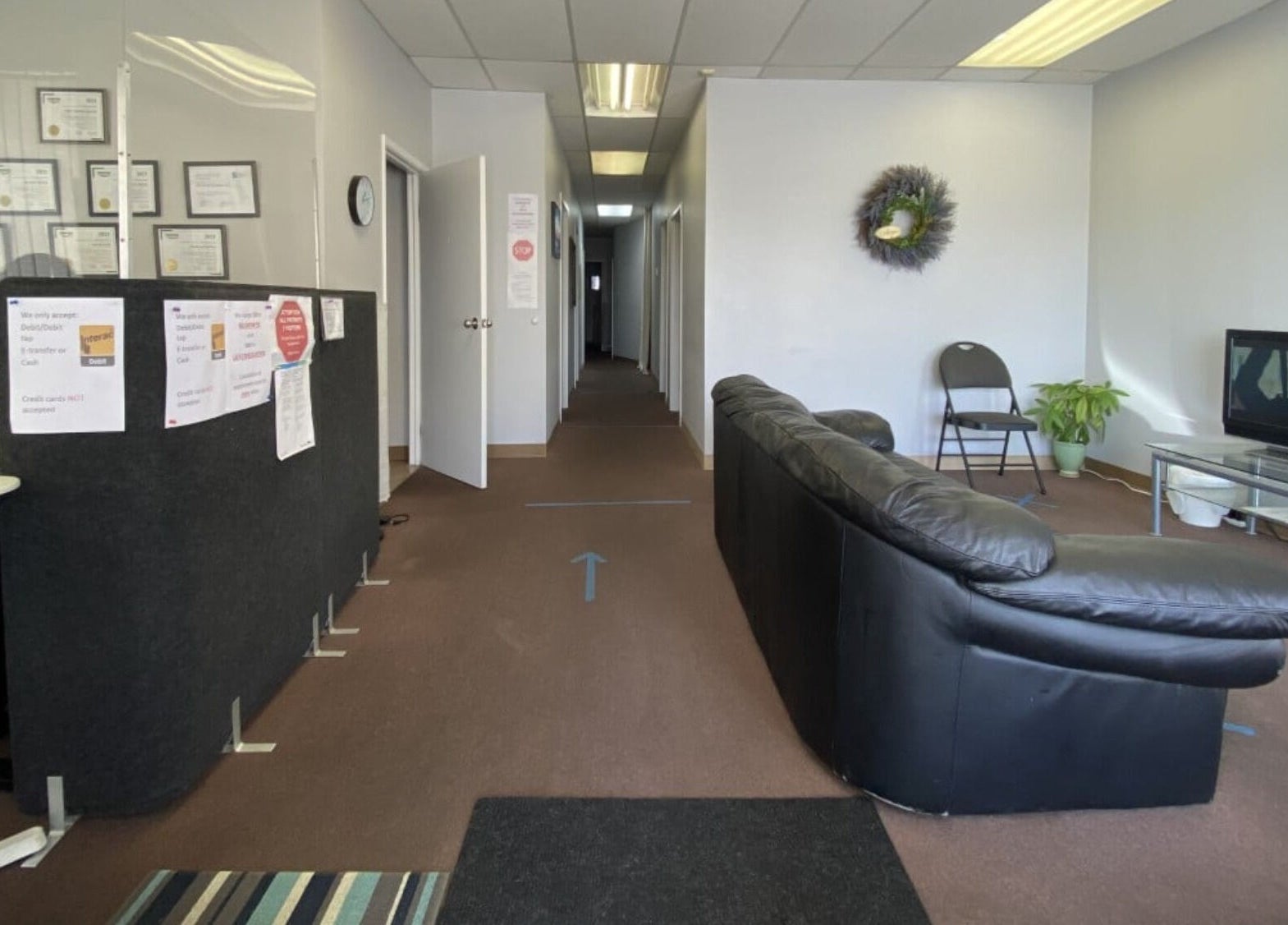 Comfortable reception area at Bluebell Health in Winnipeg, Manitoba, CA, featuring a black sofa and inviting decor.