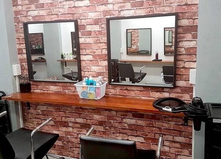 Stylish salon interior at Top Katz, Wynnum, Queensland, AU with brick walls and chic mirrors.