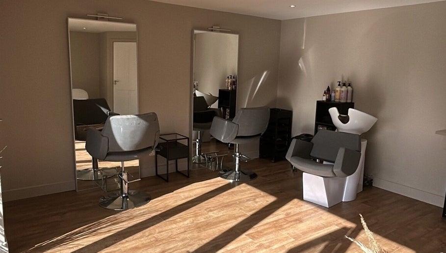Modern salon interior at Steph Skelton Hair Studio, York, England, GB with stylish chairs and mirrors.