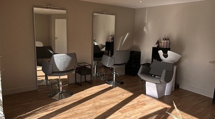 Modern salon interior at Steph Skelton Hair Studio, York, England, GB with stylish chairs and mirrors.