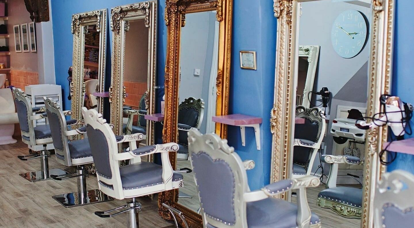 Stylish salon chairs and ornate mirrors at The Hair Room, Leicester, England, GB offering luxe beauty experience.