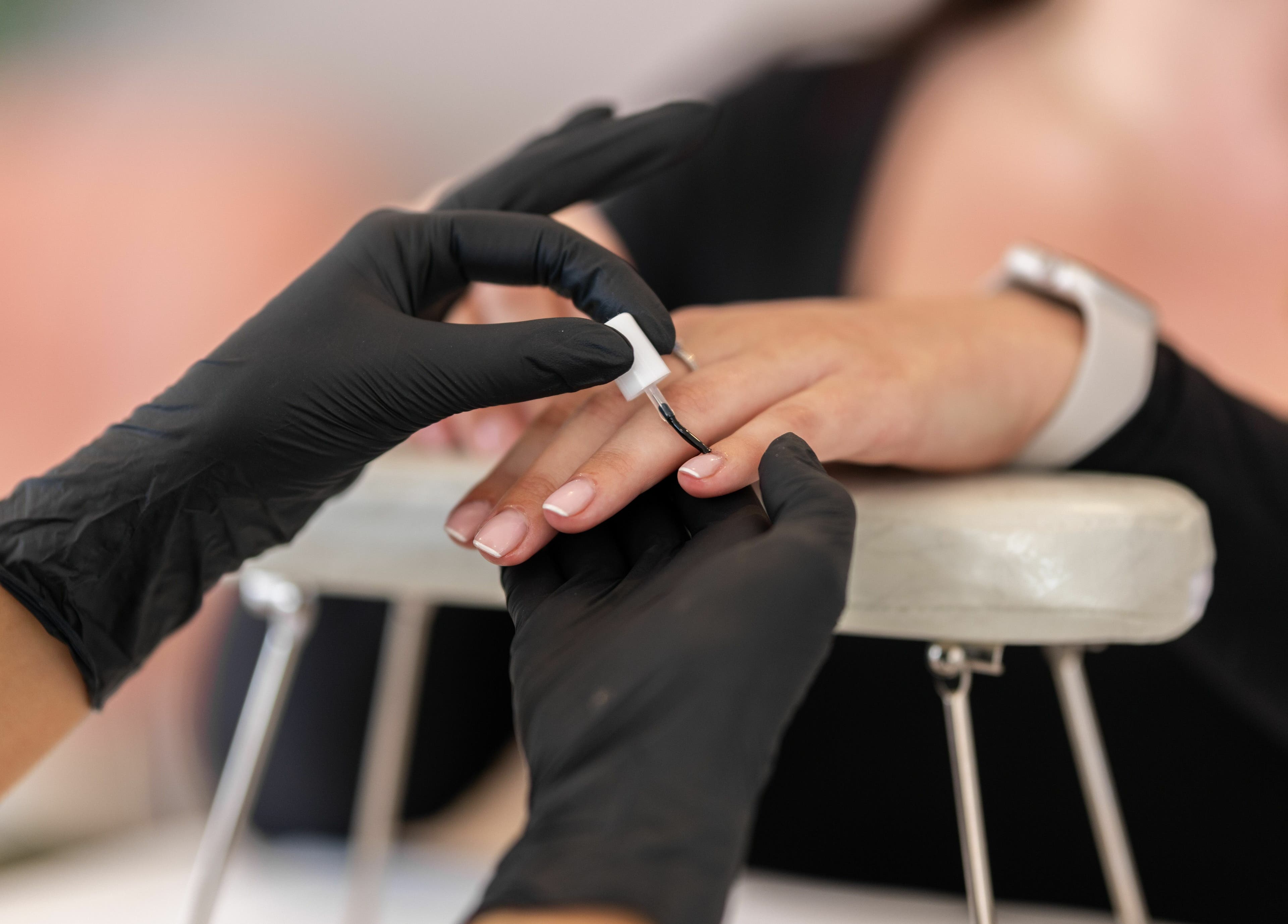 Nail technician applying polish at Pamper Parties - Bella Rose, West Wickham, England, GB.