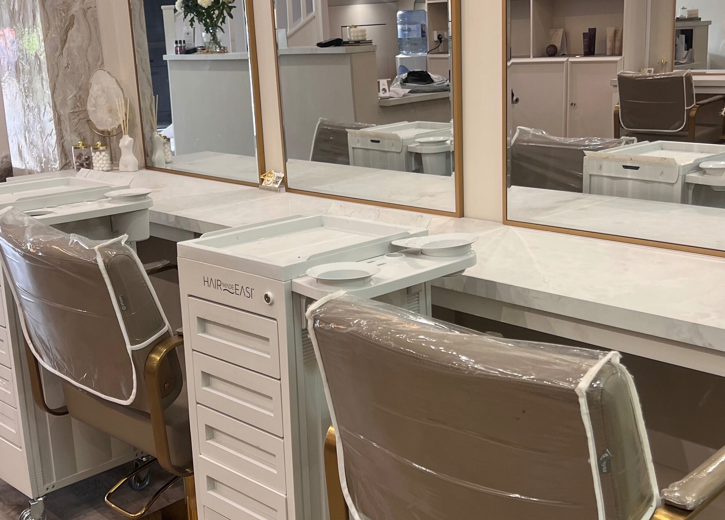 Elegant styling station at The Hair Extension Shop, West Wickham, England, GB with mirrors and chairs.
