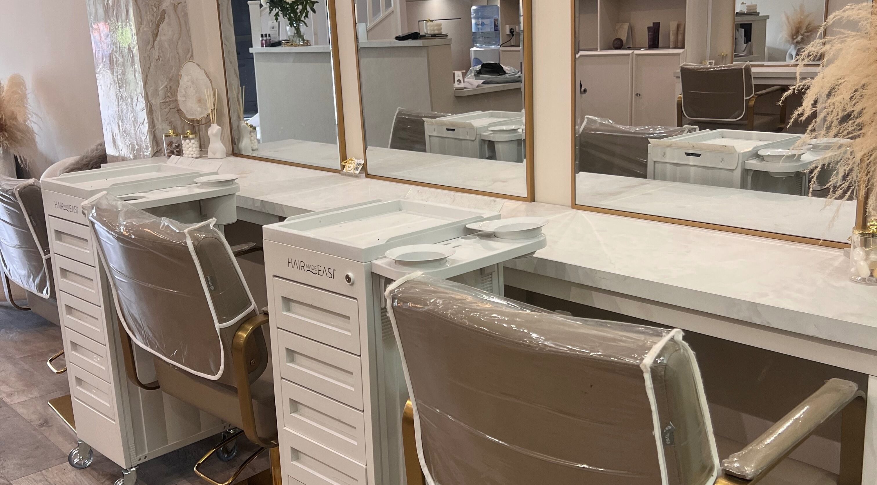 Elegant styling station at The Hair Extension Shop, West Wickham, England, GB with mirrors and chairs.
