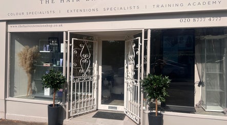 Front view of The Hair Extension Shop in West Wickham, England, GB showcasing elegant white doors and plants.