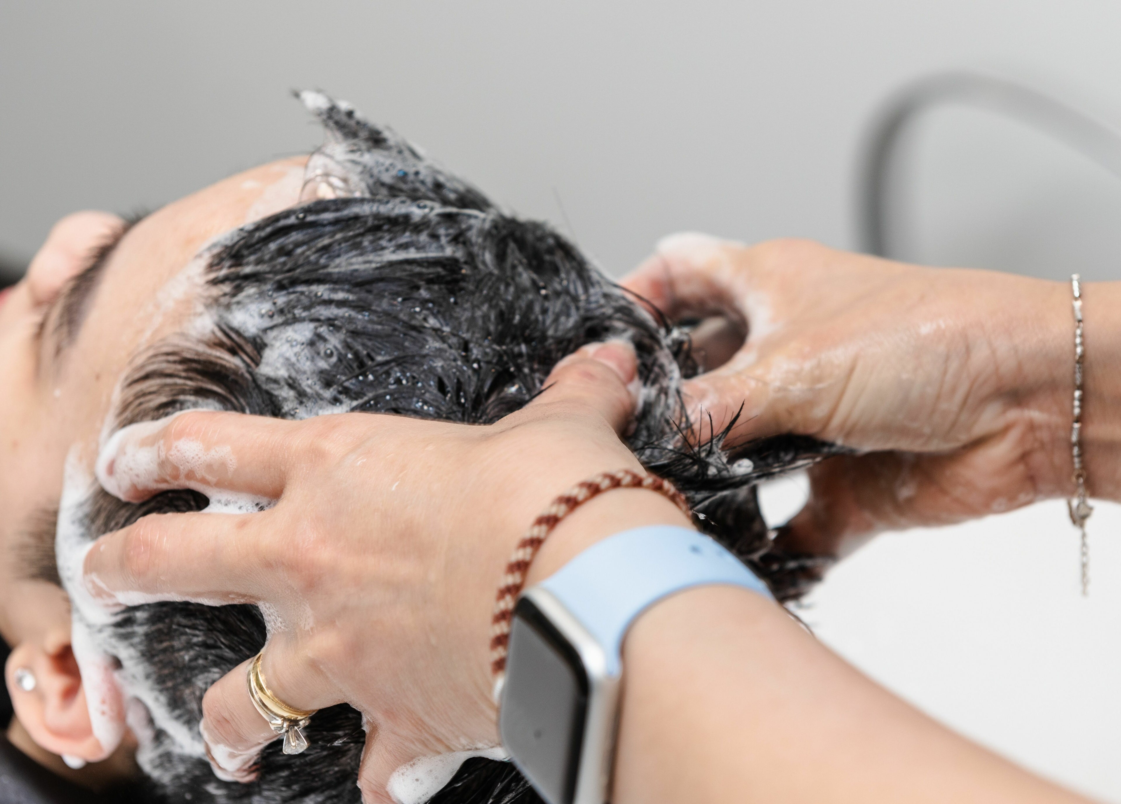 Hair wash service at Spring Hair and Nails Salon in Regina, Saskatchewan, CA, showcasing expert scalp massage.
