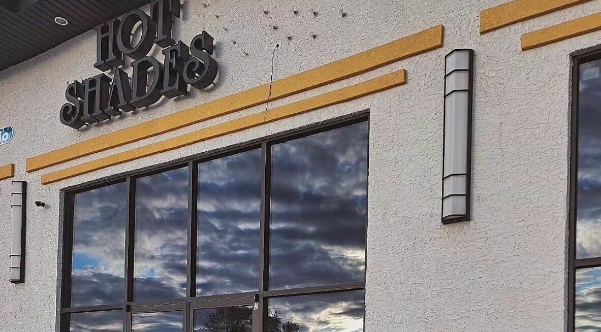 Entrance of Hot Shades Salon in Pilot Butte, Saskatchewan, CA with stylish exterior design.