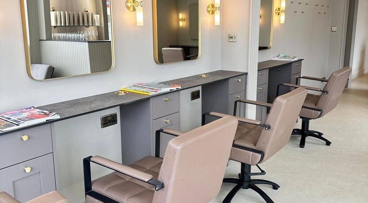 Elegant salon chairs and mirrors at Cavell & Co., Norwich, England, GB.