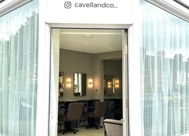 Exterior view of Cavell & Co., a chic salon in Norwich, England, GB with large glass windows.