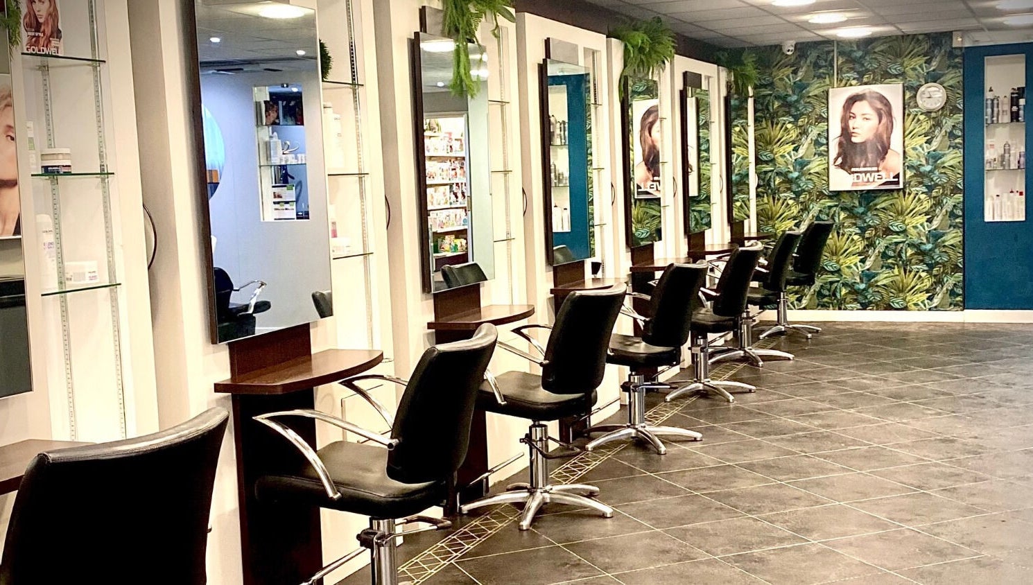 Modern salon interior at hairstyles@wetherells, Selby, England, GB with sleek chairs and vibrant decor.