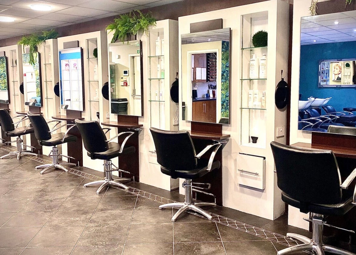 Modern salon interiors at hairstyles@wetherells in Selby, England, GB with stylish workstations and mirrors.