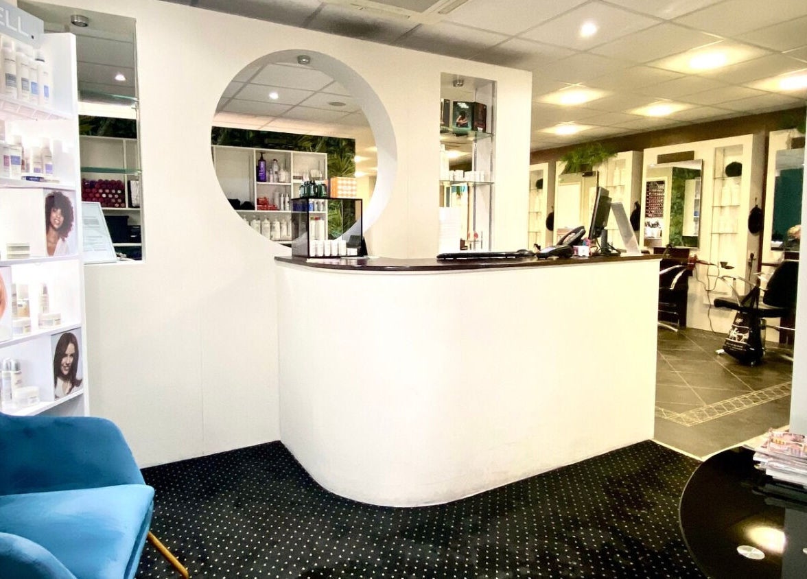 Reception area of hairstyles@wetherells in Selby, England, GB, showcasing modern interior and hair products.
