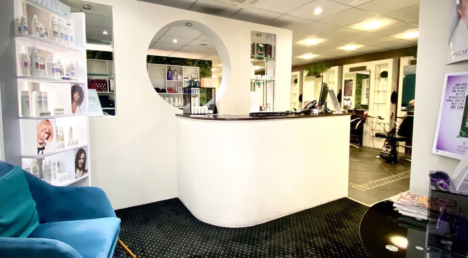 Reception area of hairstyles@wetherells in Selby, England, GB, showcasing modern interior and hair products.