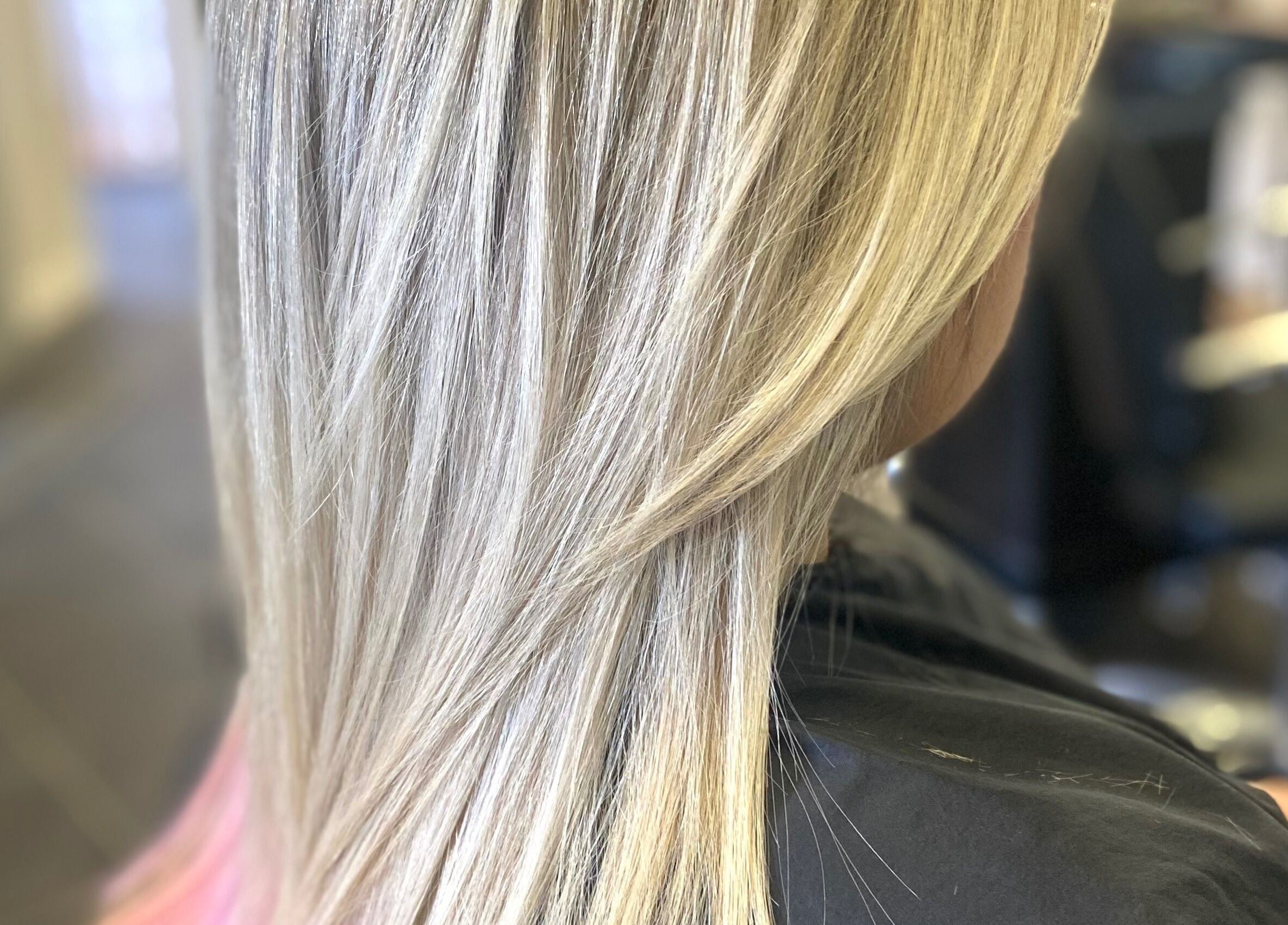 Close-up of silky blonde hair at hairstyles@wetherells, Selby, England, GB. Offers expert styling services.