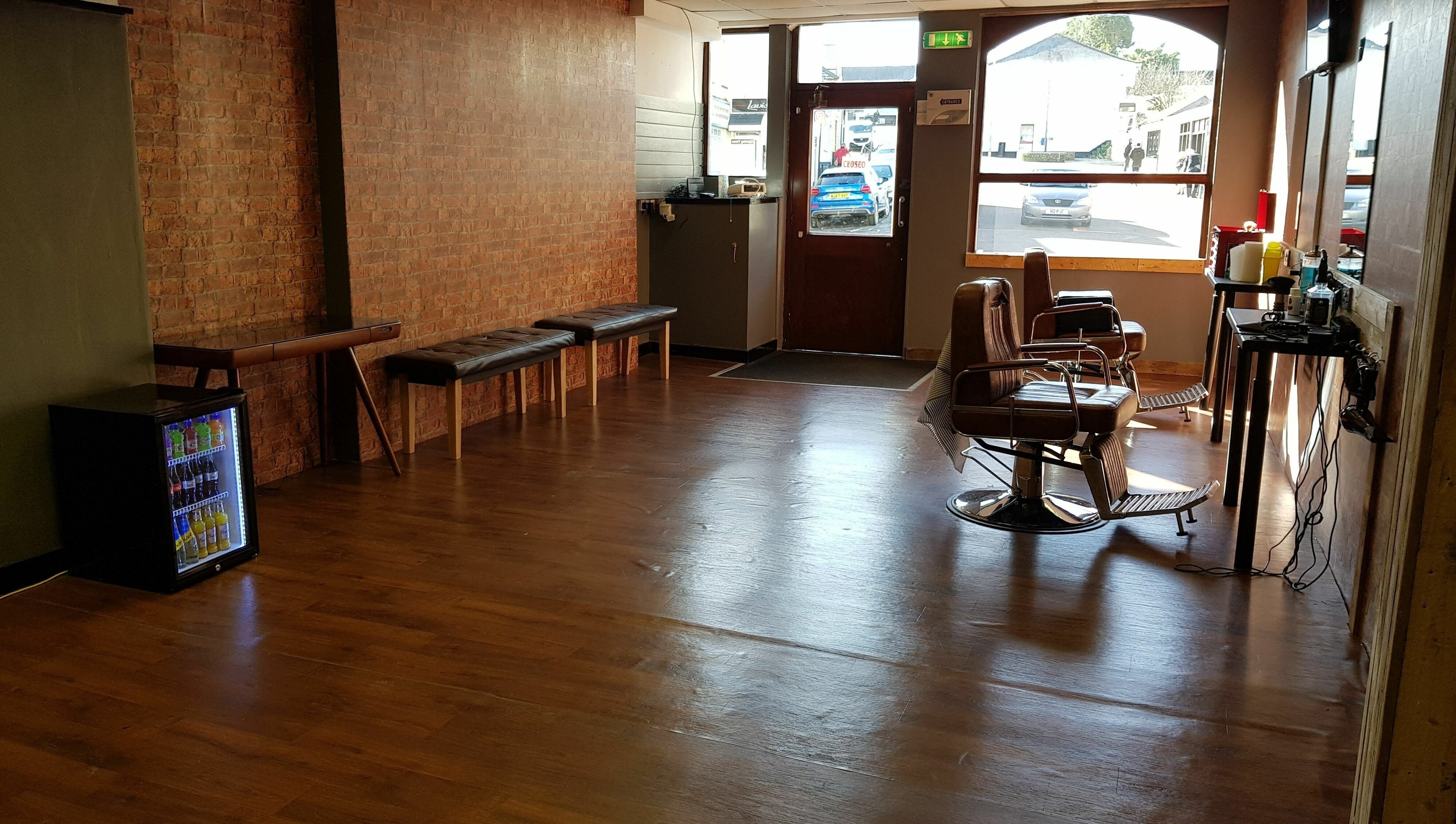 Cozy interior of Barnets and Beards Barbershop, Callington, England, GB with vintage barber chairs.