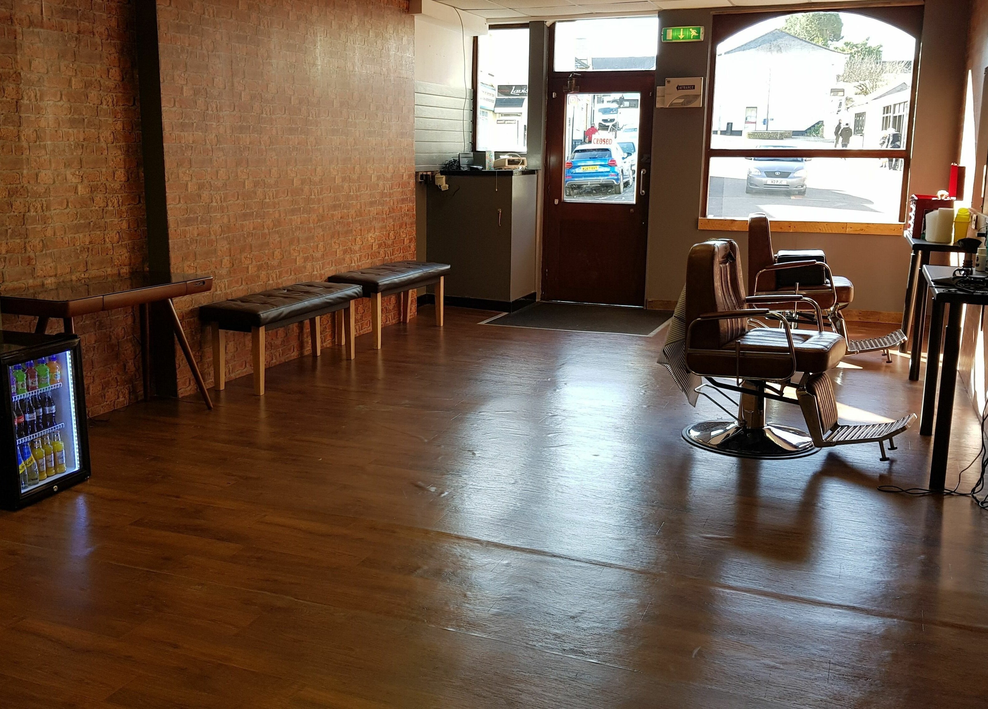 Cozy interior of Barnets and Beards Barbershop, Callington, England, GB with vintage barber chairs.