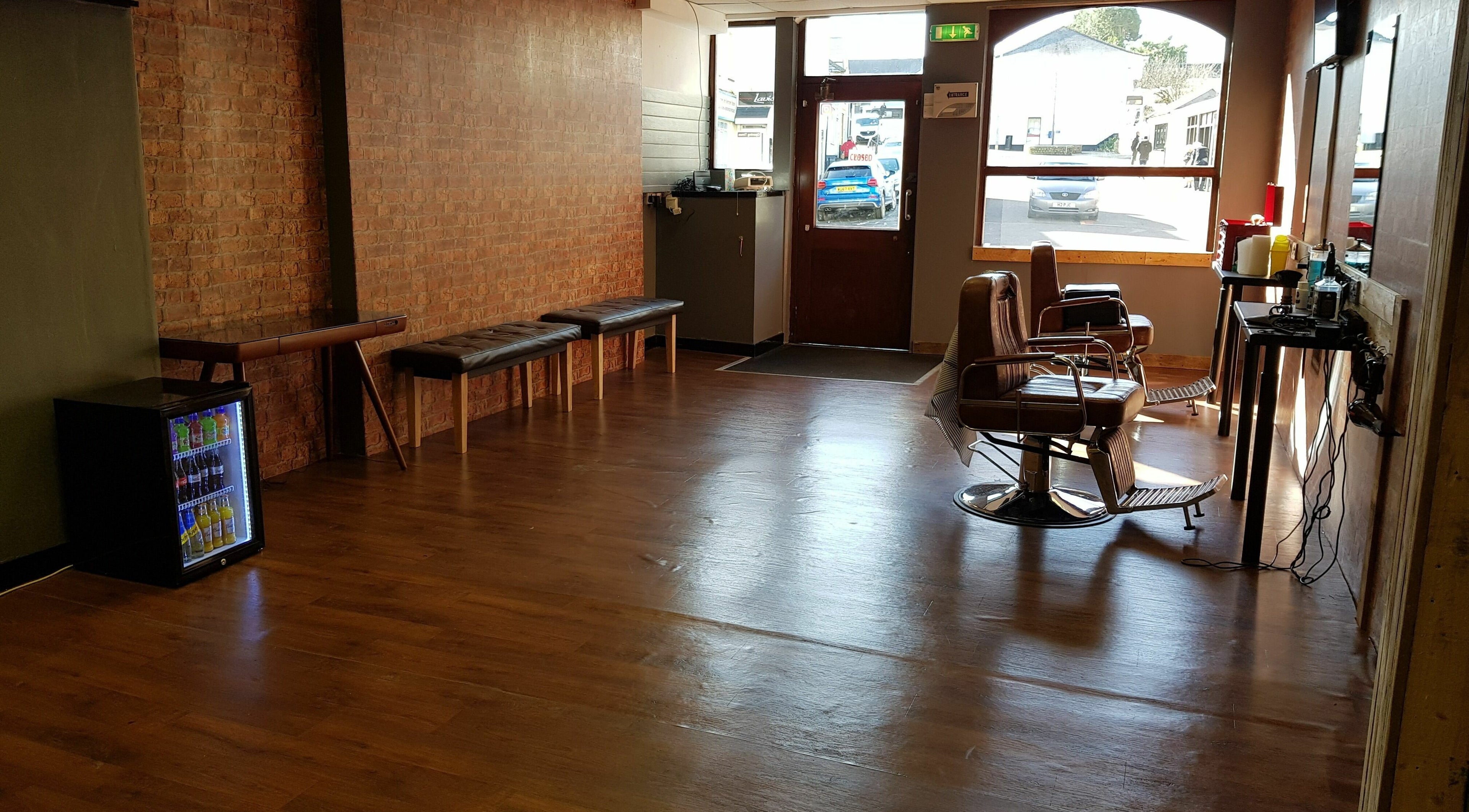 Cozy interior of Barnets and Beards Barbershop, Callington, England, GB with vintage barber chairs.