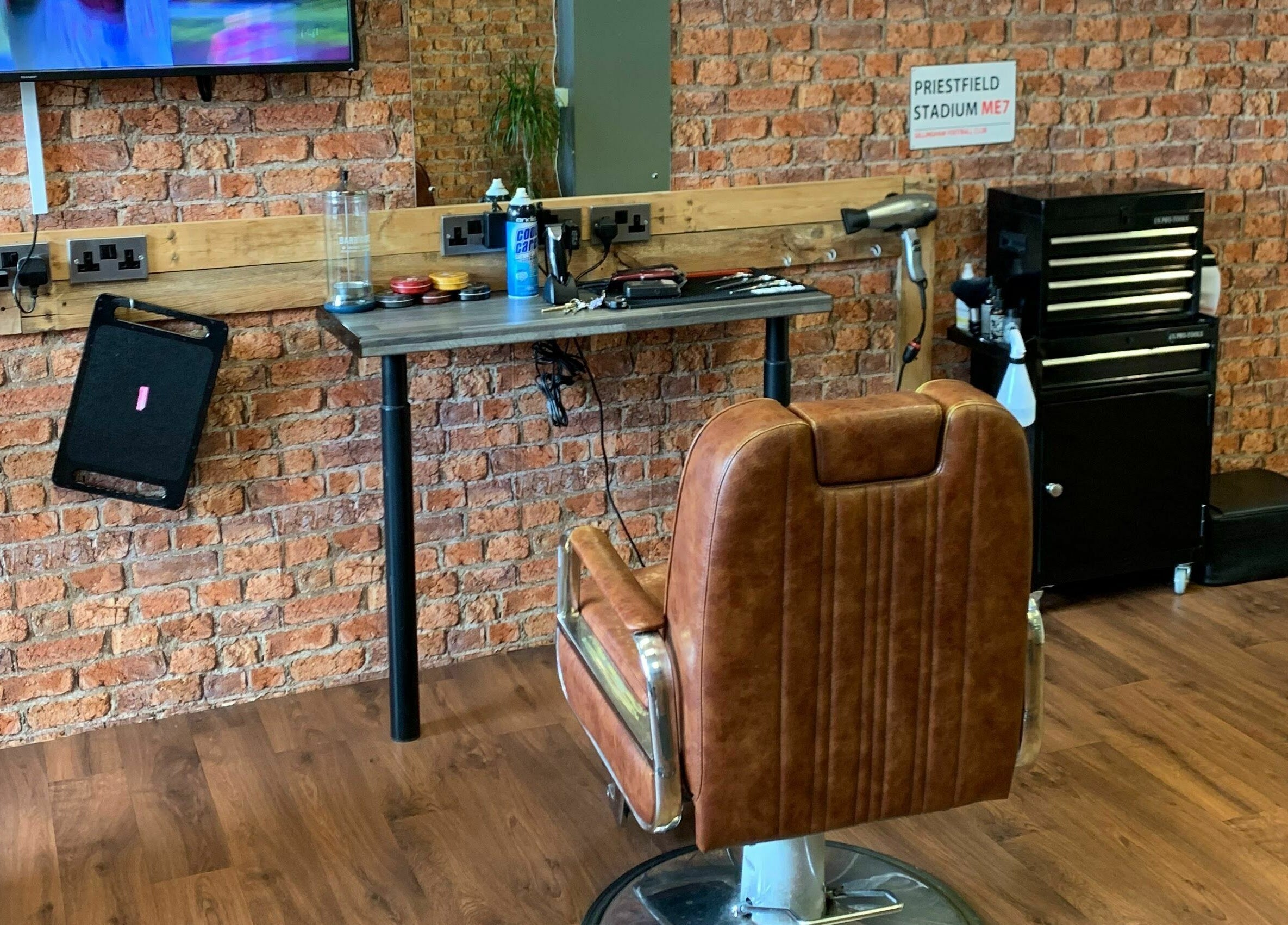 Cozy barbershop chair and rustic decor at Barnets and Beards Barbershop, Callington, England, GB.