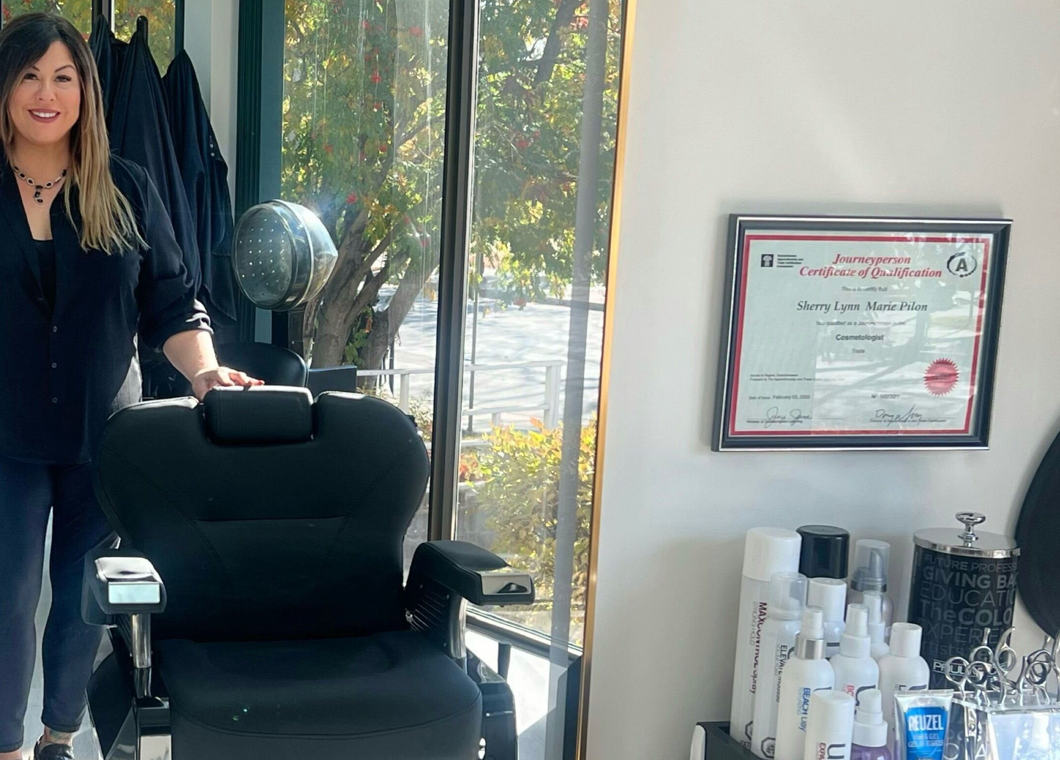 Impressions Salon - Saskatoon stylist at workstation with certificate on wall, Saskatoon, Saskatchewan, CA.