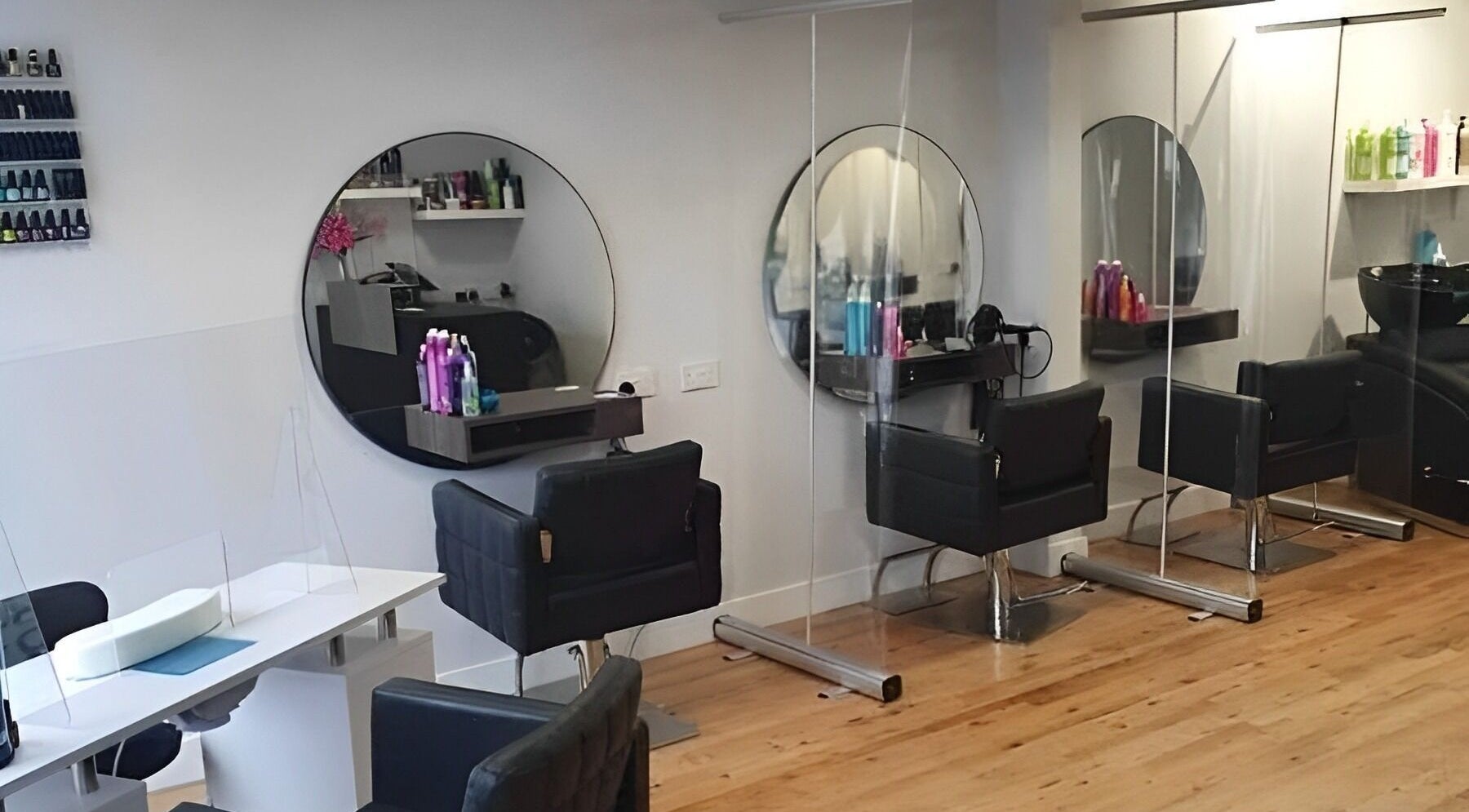 Modern salon interior at Hair Bare (Southern) Ltd, Southampton, England, GB showcasing stylish chairs and mirrors.