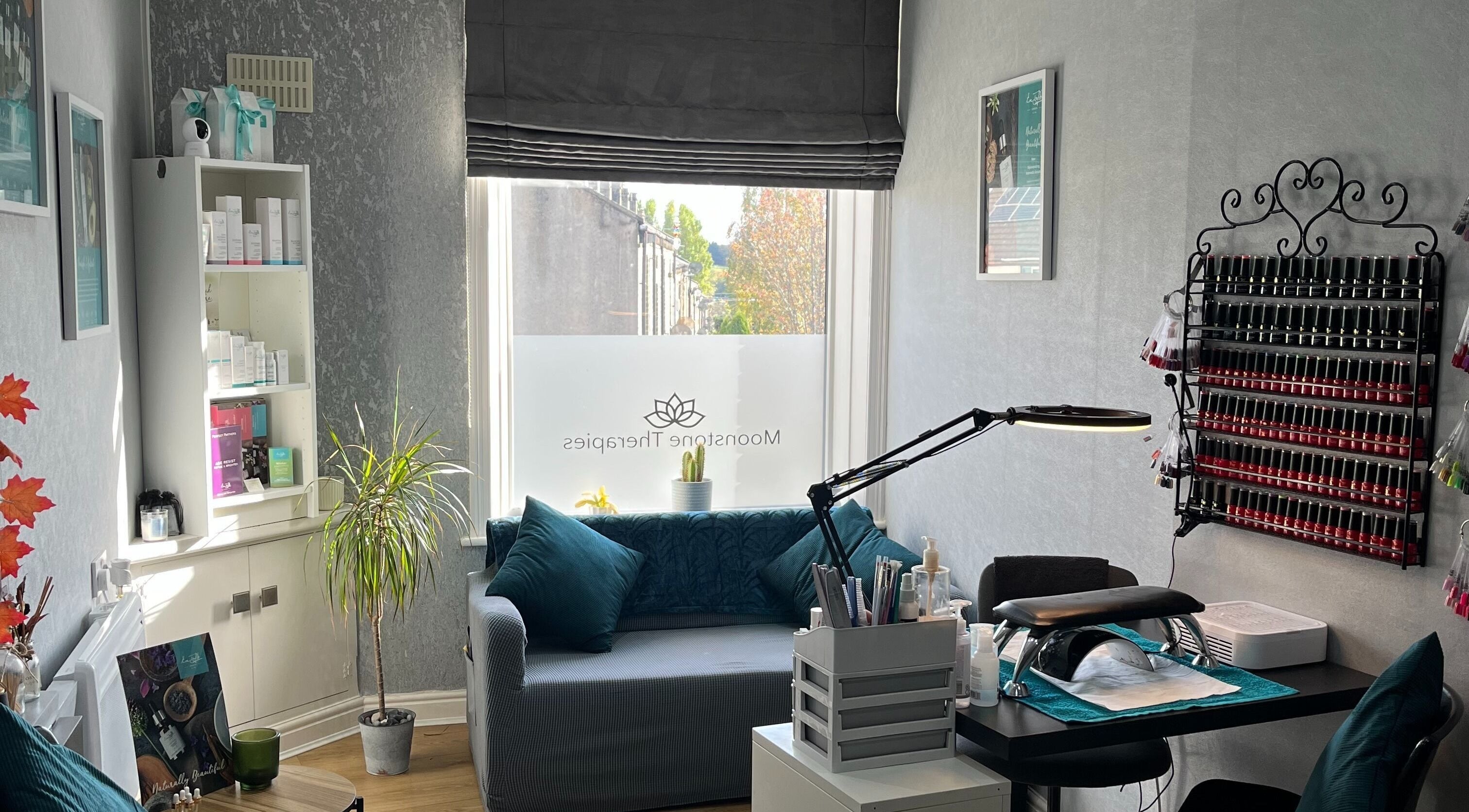 Tranquil therapy room at Moonstone Therapies, Brighouse, England, with cozy seating and nail care setup.