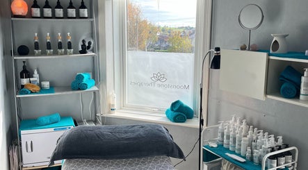 Cozy treatment room at Moonstone Therapies in Brighouse, England, GB, showcasing skincare products and turquoise towels.