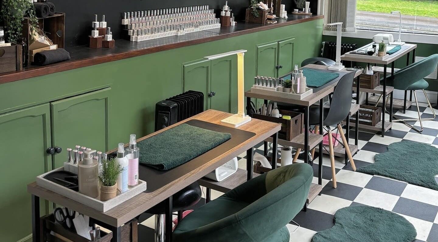 Cozy interior of Station Beauty nail salon in Whitehill, England, GB, featuring stylish manicure stations and decor.