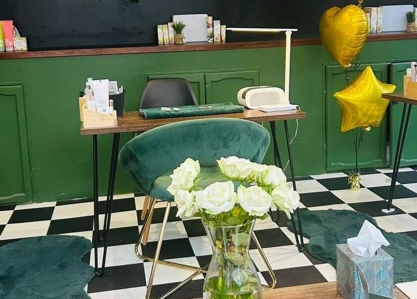 Elegant beauty station at Station Beauty, Whitehill, England, GB with green decor and balloons.