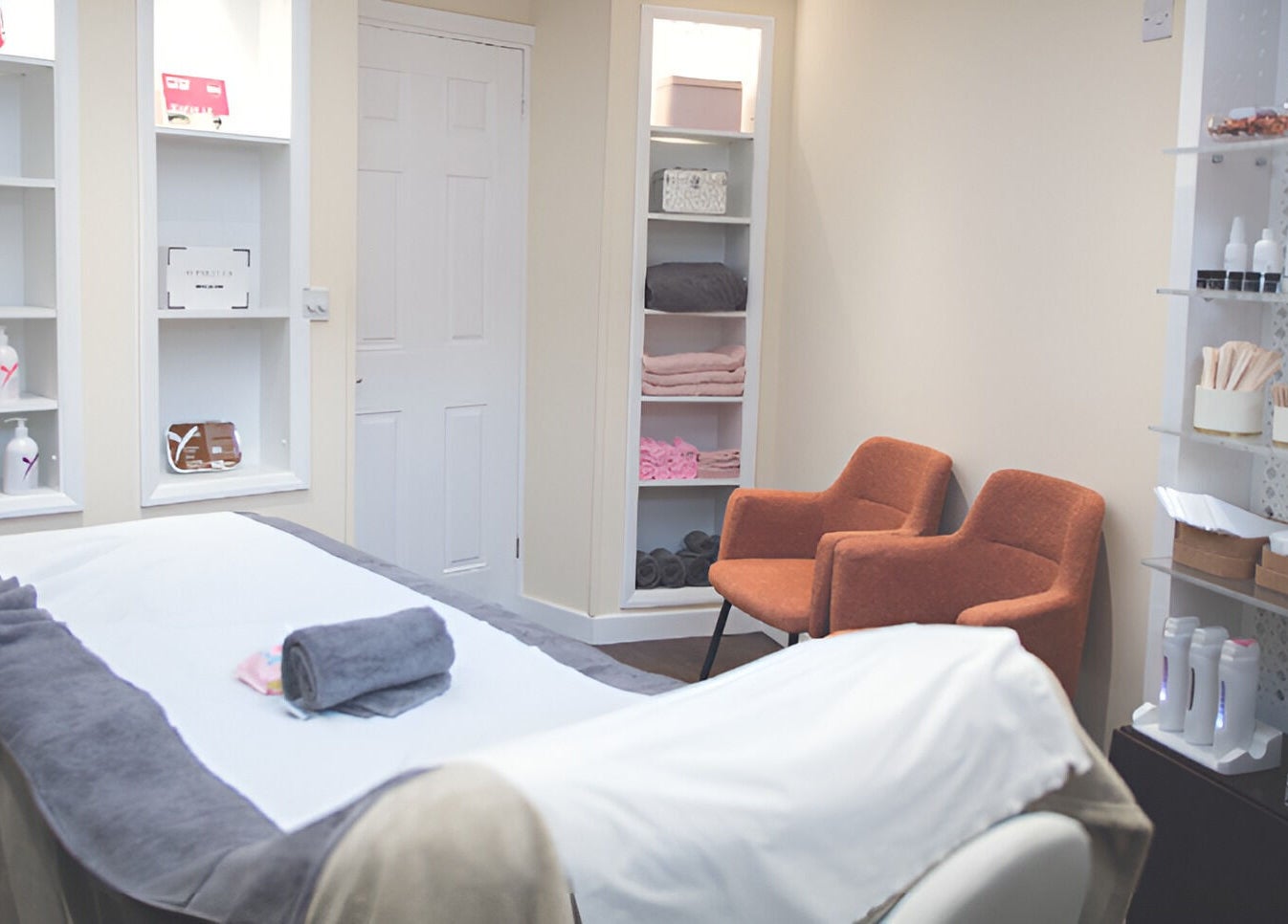 Relaxing treatment room at WAX & GLO in Penarth, Wales, GB with a cozy massage table and elegant decor.