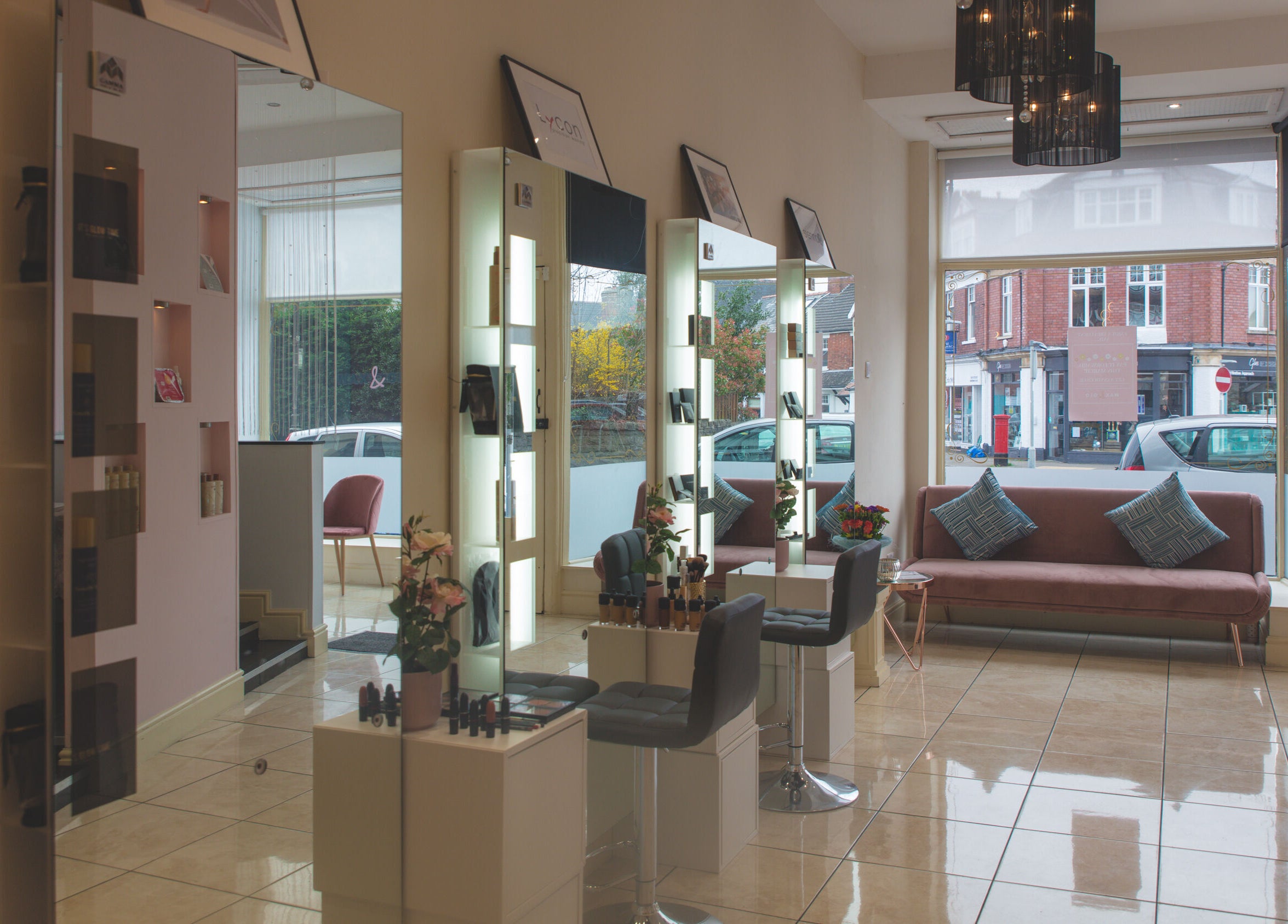 WAX & GLO salon interior showcasing modern seating and styling stations in Penarth, Wales, GB.