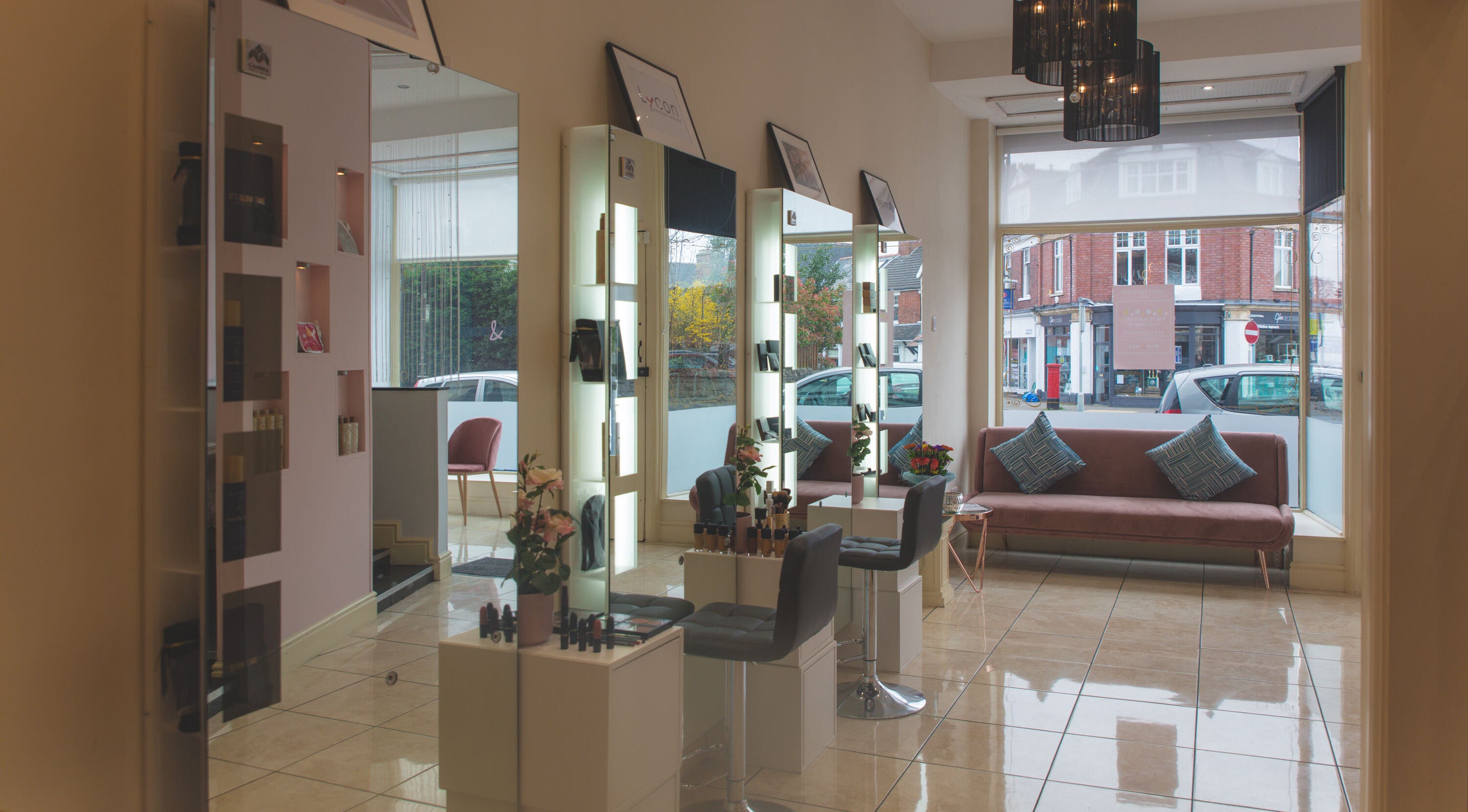 WAX & GLO salon interior showcasing modern seating and styling stations in Penarth, Wales, GB.