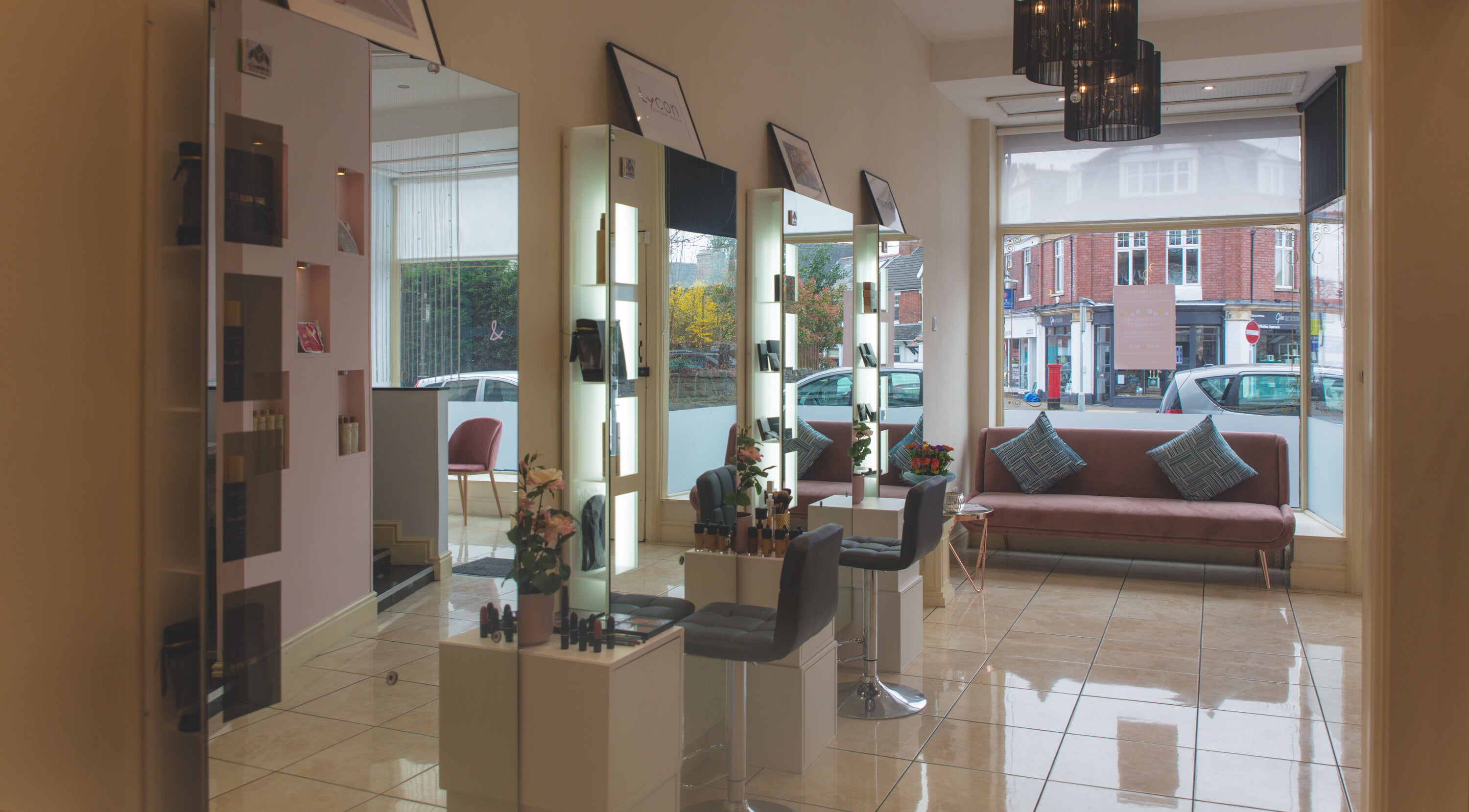 WAX & GLO salon interior showcasing modern seating and styling stations in Penarth, Wales, GB.