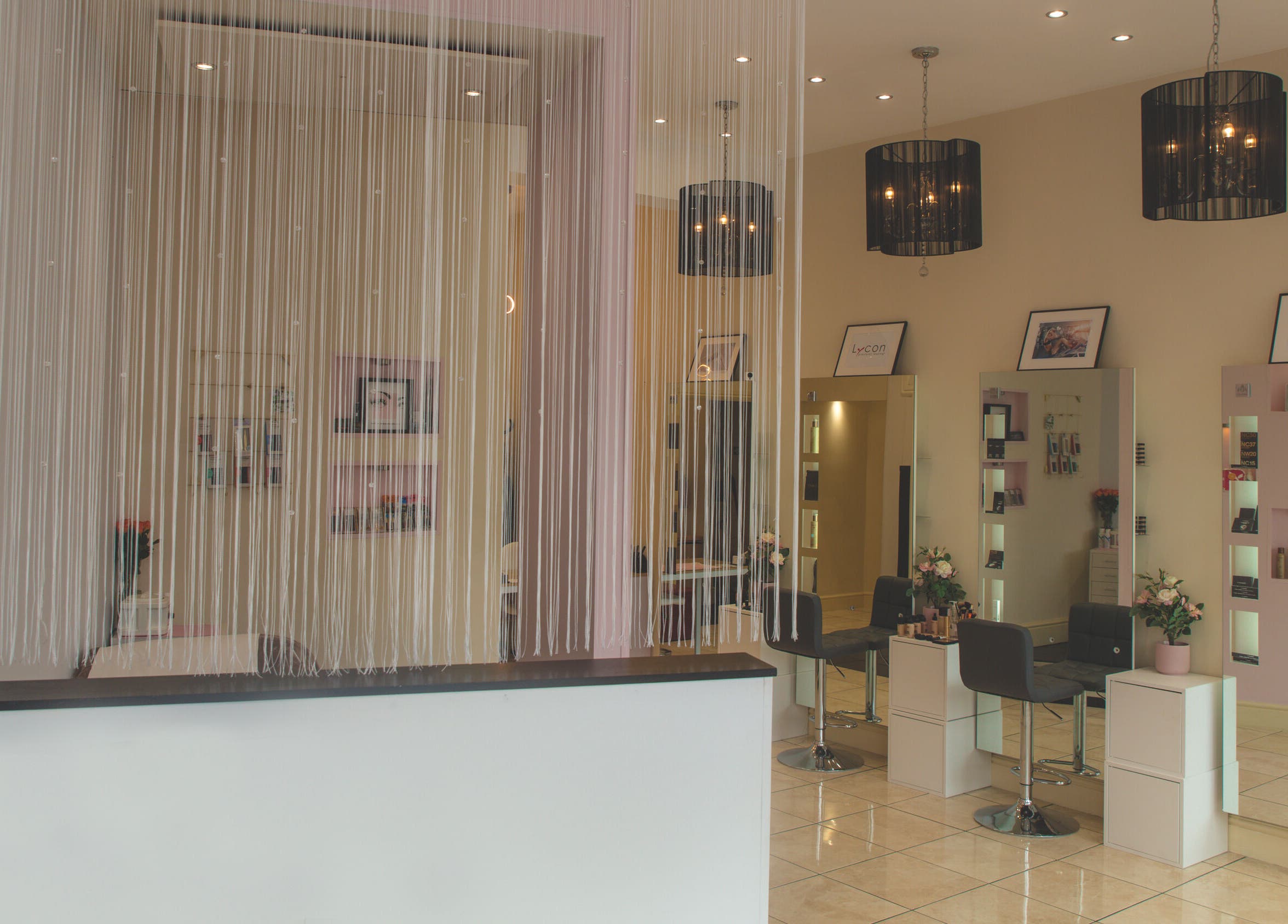 Stylish interior of WAX & GLO in Penarth, Wales, GB with elegant furnishings and modern lighting.