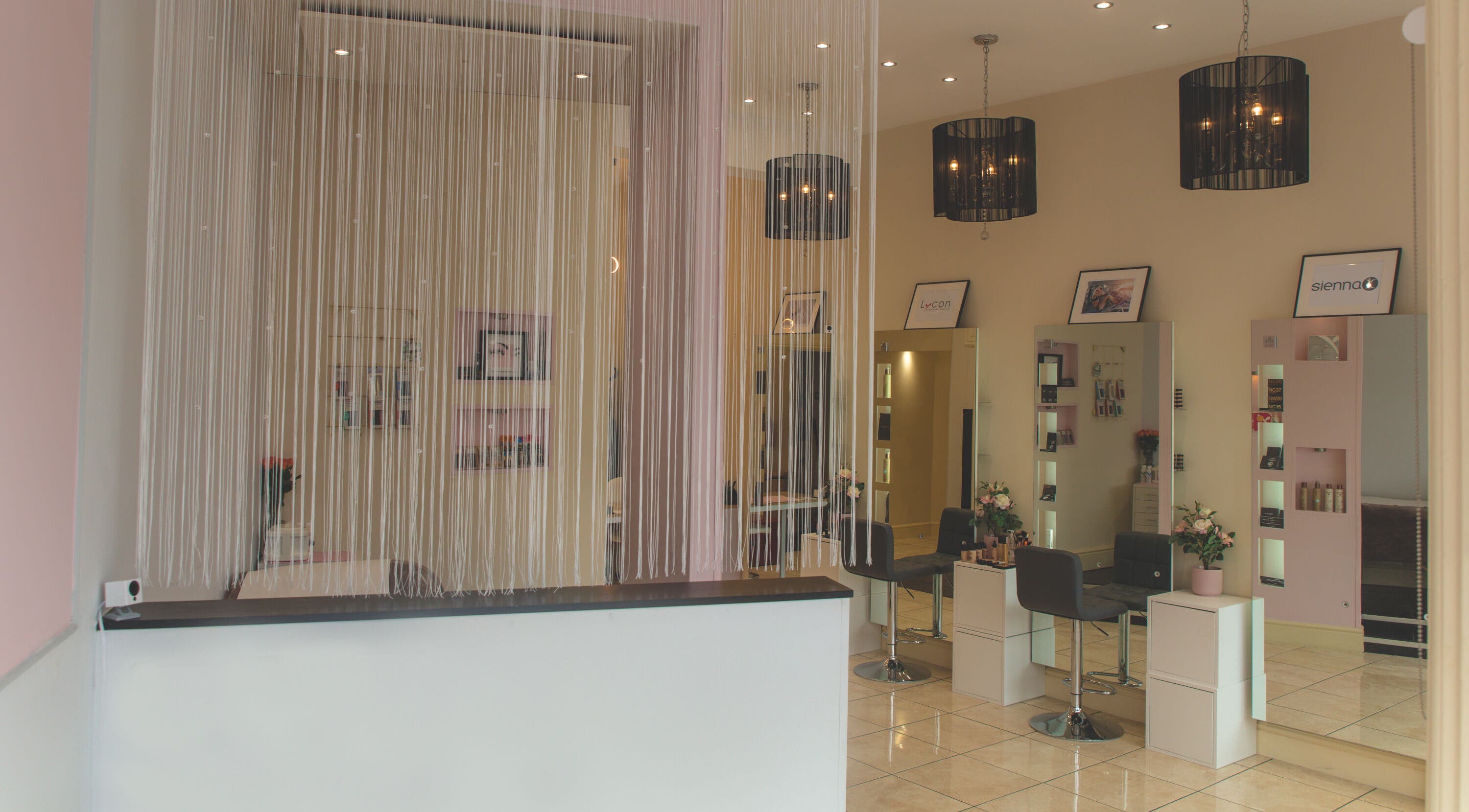 Stylish interior of WAX & GLO in Penarth, Wales, GB with elegant furnishings and modern lighting.