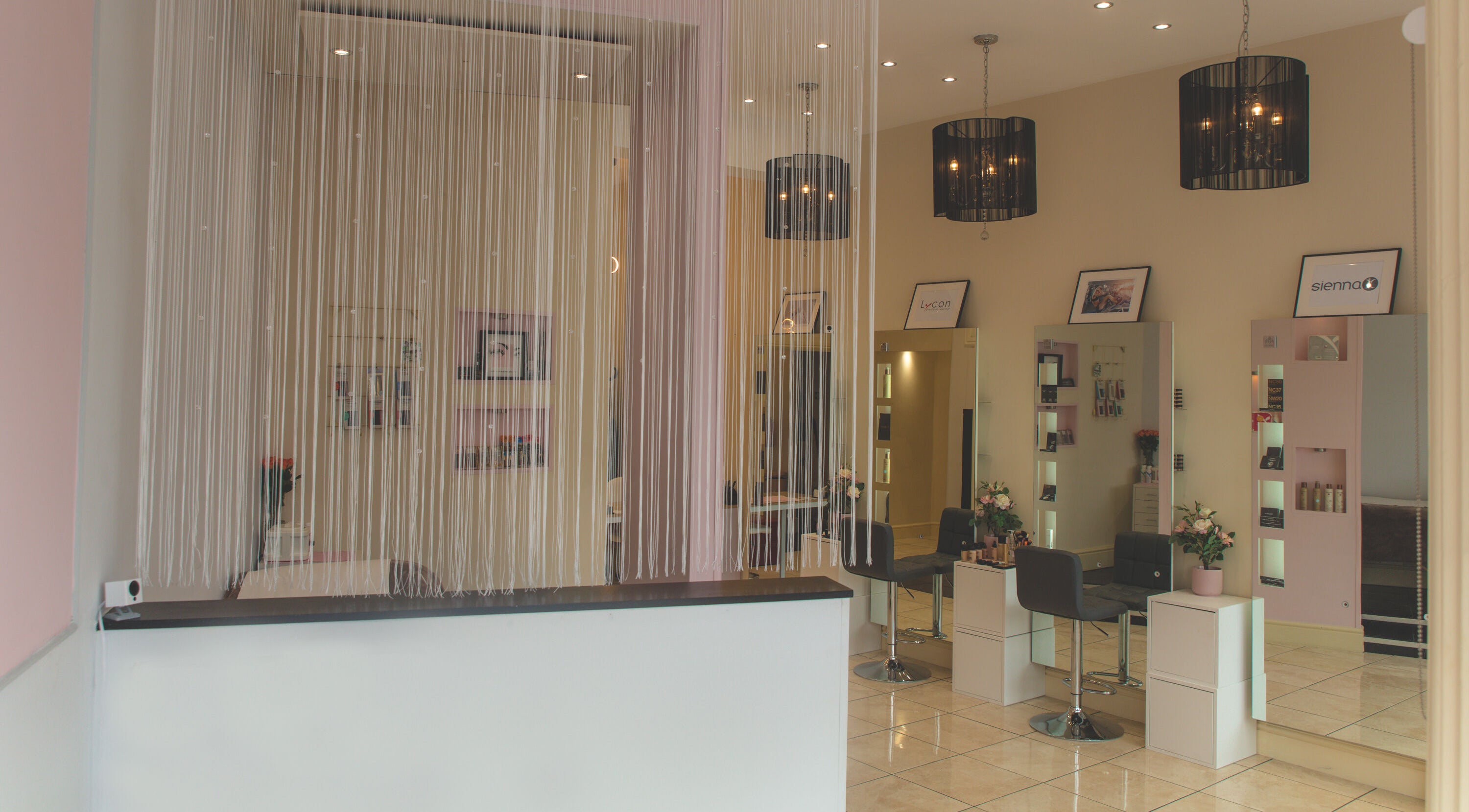 Stylish interior of WAX & GLO in Penarth, Wales, GB with elegant furnishings and modern lighting.