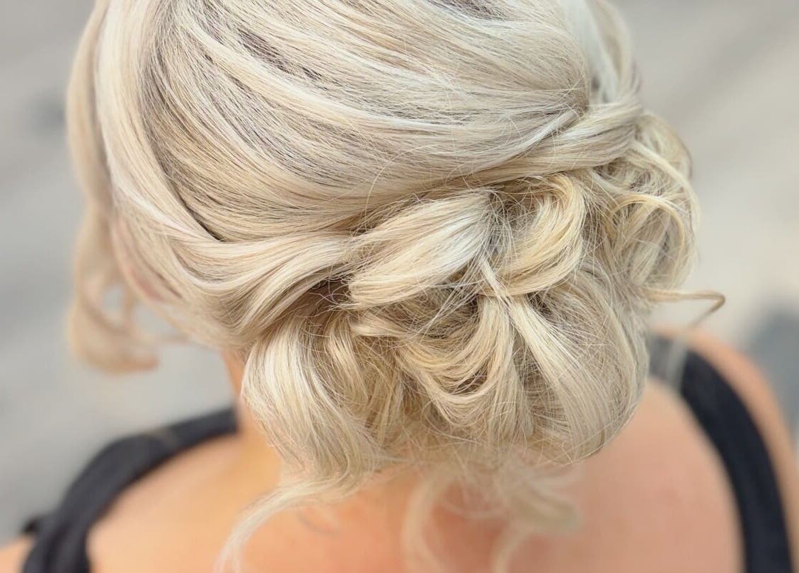 Elegant updo hairstyle by By Rayner in Warrington, GB, showcasing intricate blonde curls.
