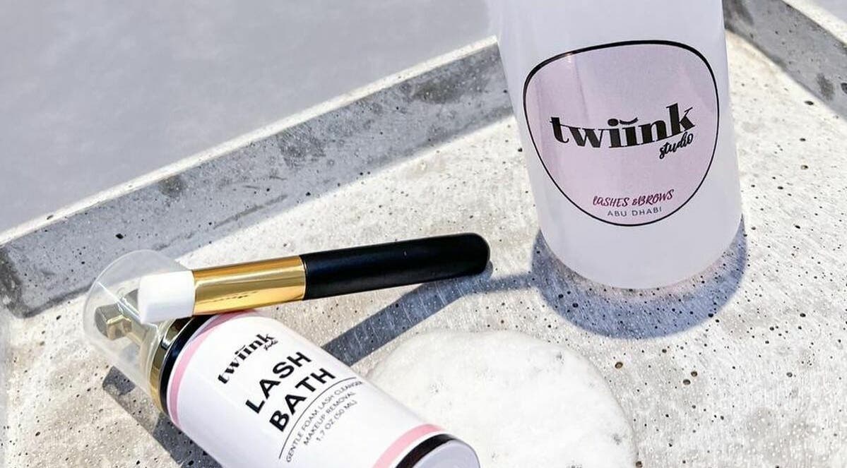Lash Bath and brush from Twiink Studio, Abu Dhabi, AE displayed elegantly on concrete surface.