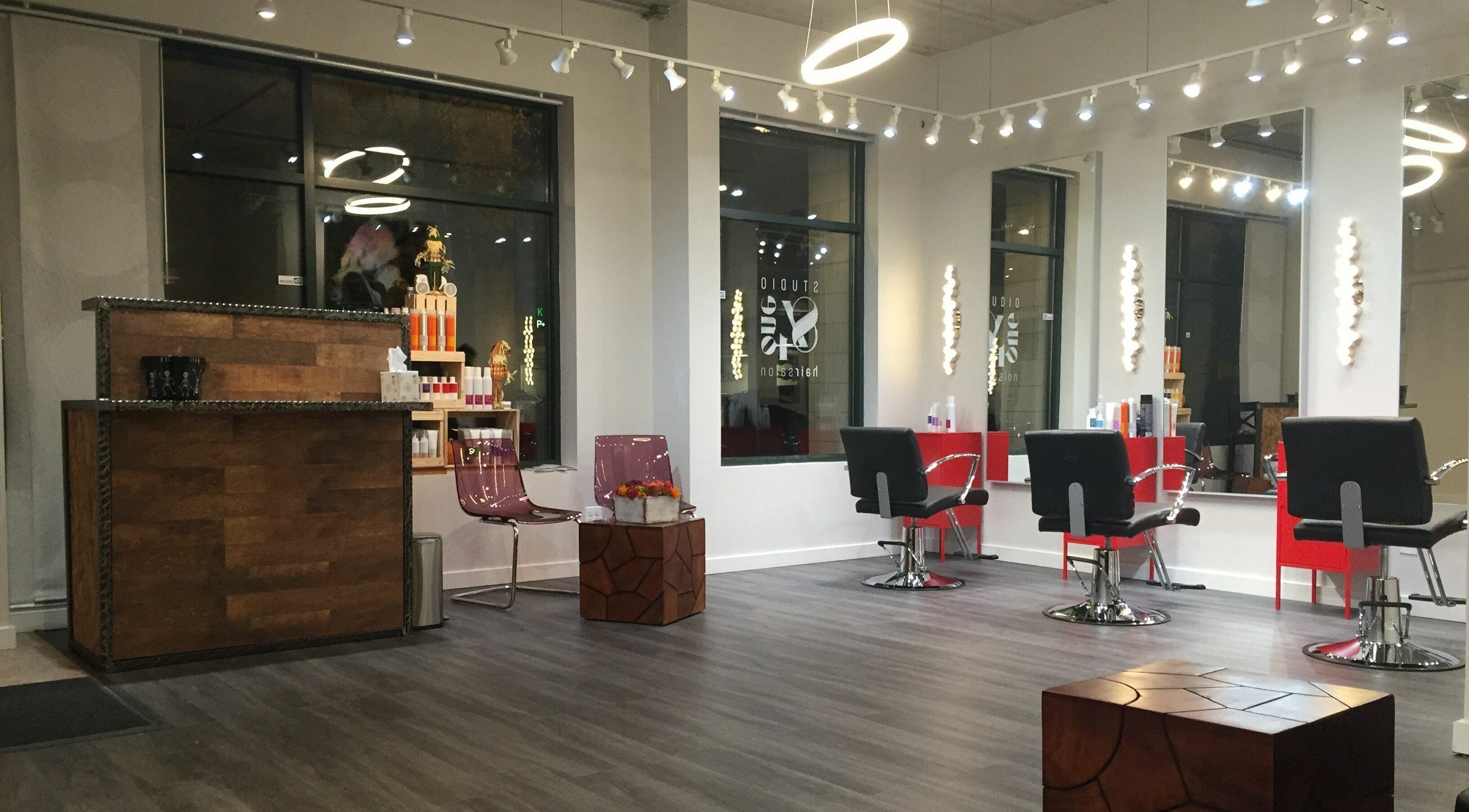 Modern interior of Studio 84one in Chicago, Illinois, US with sleek salon chairs and stylish decor.