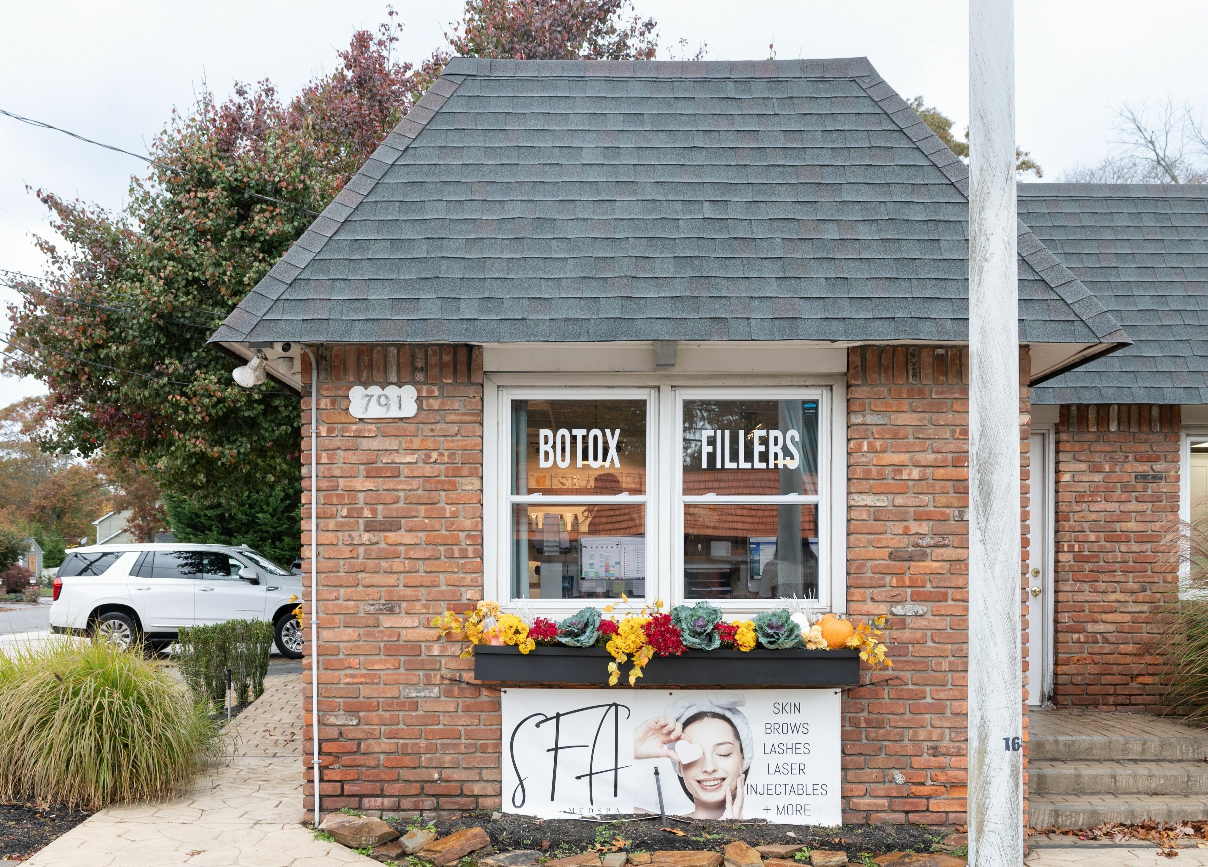Charming brick facade of Simply Fresh Aesthetics in Miller Place, New York, US with Botox and Fillers signage.