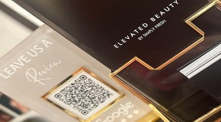 Display at Elevated Beauty by SFA, Miller Place, NY with review sign and QR code.
