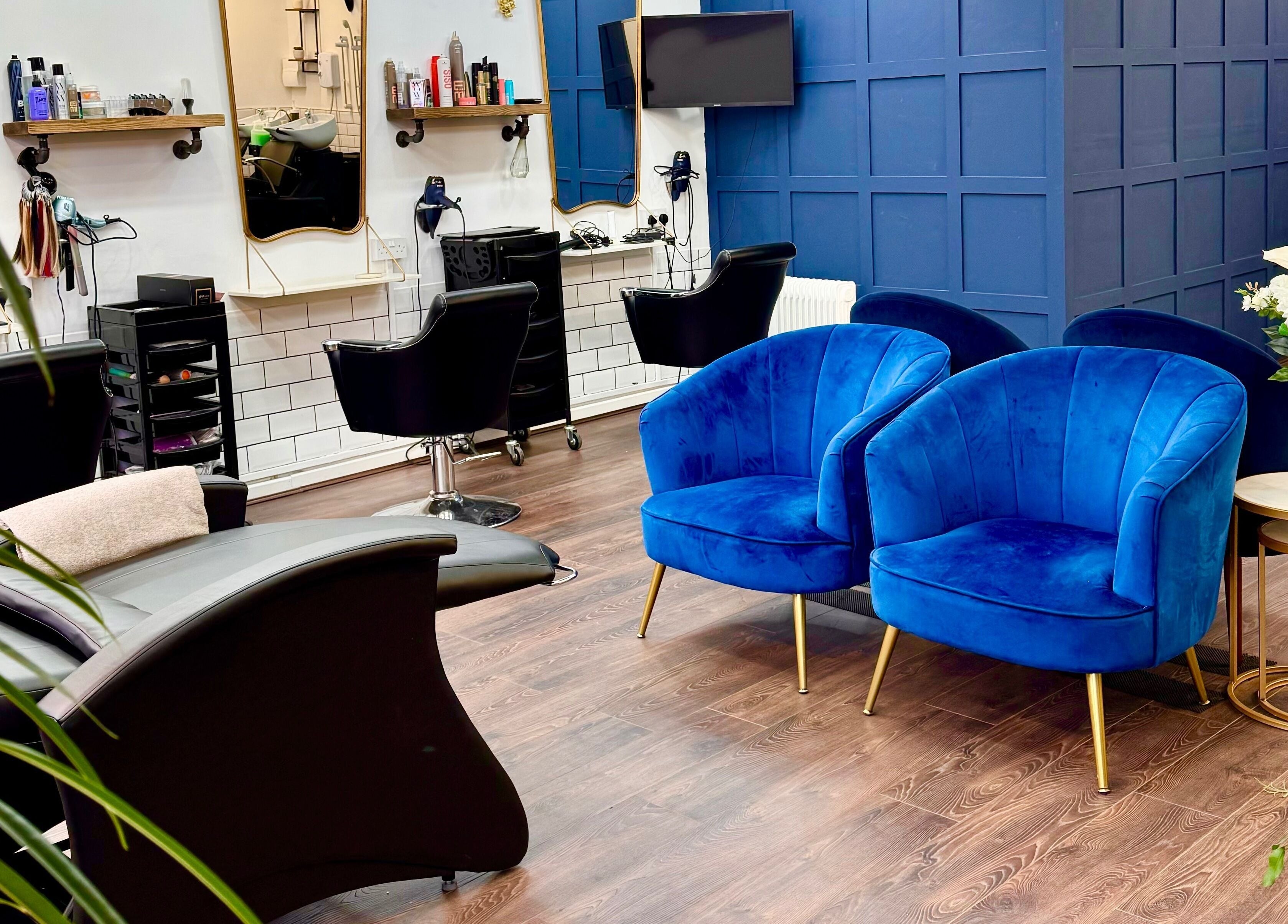 Elegant seating in David Brown Hairdressing and Aesthetics, Northampton, England, GB features plush blue chairs.