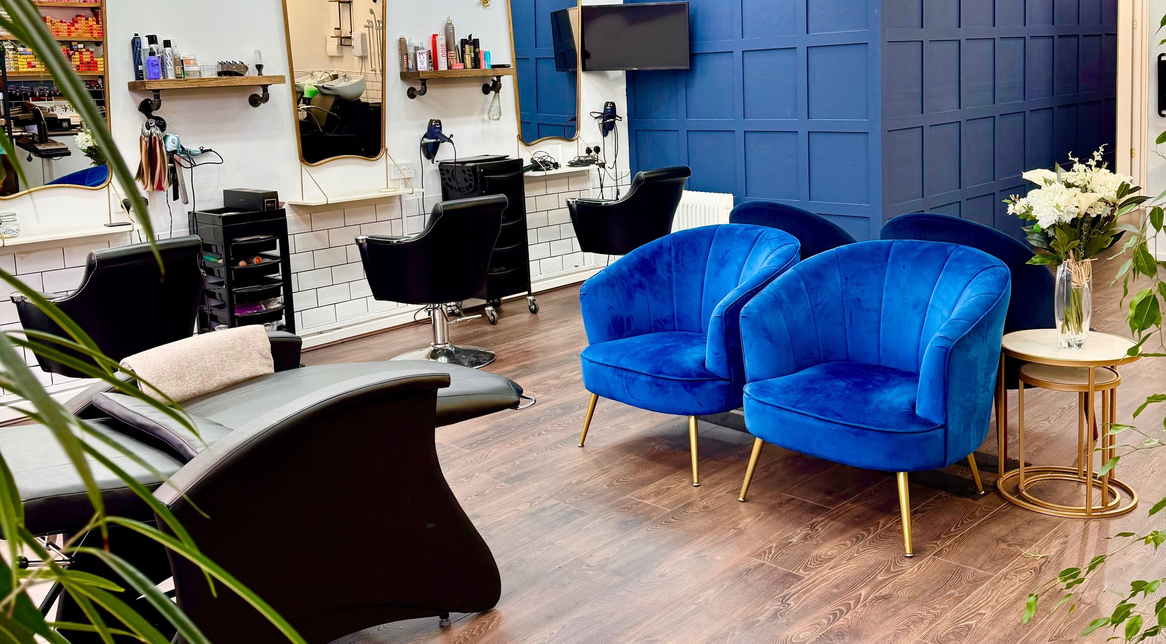 Elegant seating in David Brown Hairdressing and Aesthetics, Northampton, England, GB features plush blue chairs.