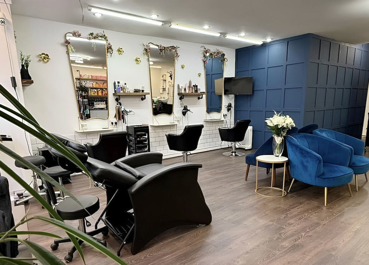 Interior of David Brown Hairdressing and Aesthetics in Northampton, England, GB, featuring stylish seating.