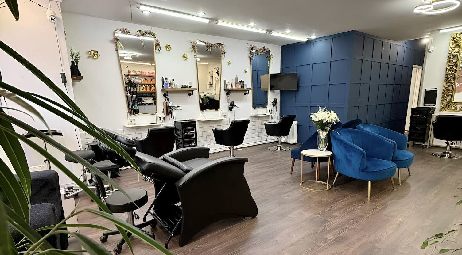 Interior of David Brown Hairdressing and Aesthetics in Northampton, England, GB, featuring stylish seating.
