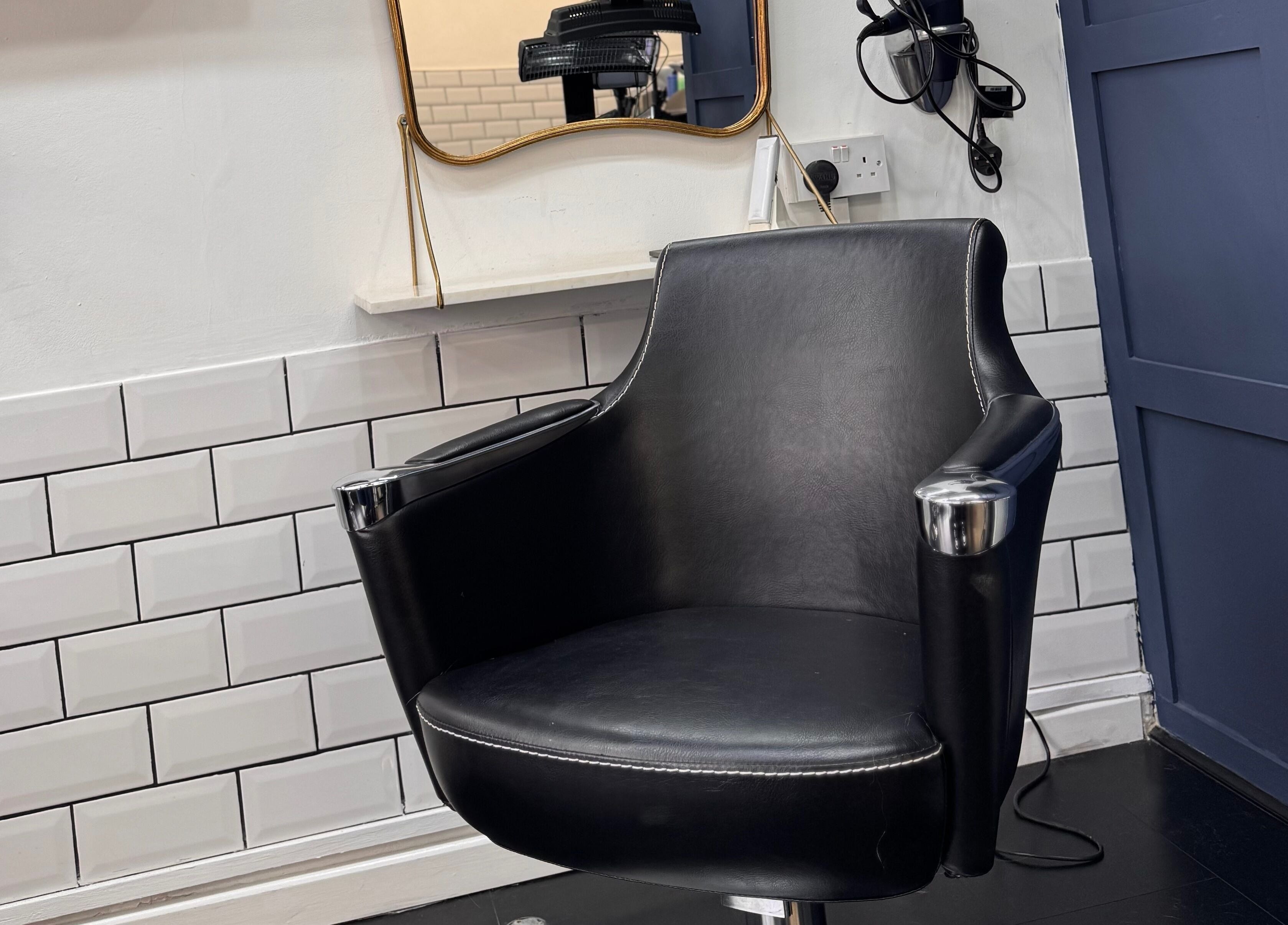 Sleek salon chair at David Brown Hairdressing and Aesthetics, Northampton, England, GB, enhancing client comfort.